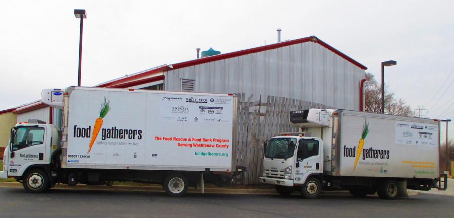 Food Gatherers trucks parked beside warehouse. These trucks are used to collect food from food donors and other partners of Food Gatherers. Trucks are used to collect and rescue food from stores almost every weekday. Volunteers help load the trucks at retailers and unload and sort the food at the warehouse where the food is stored before given to partnering programs.     