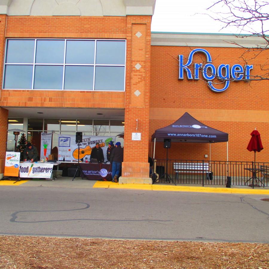 Food Gatherers outside a Kroger store promoting its organization as it collects money and educates people about hunger. Alongside, Food Gatherers is Ann Arbors local radio station 107 one volunteering during Food Gatherers annual special event “Rockin’ For The Hungry” Kroger is one of many Food Gatherers food donors.