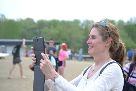 Laura Hampton takes pictures as her daughter comes back to land after finishing first in the Women's Varsity Double.