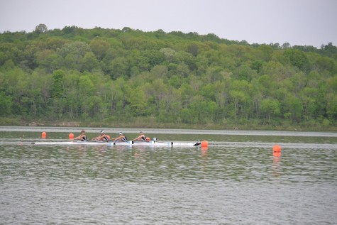 The Men's Varsity Quad crosses the finish line in first.